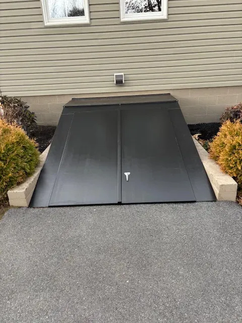 a clean and freshly installed black cellar door