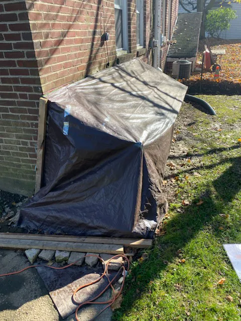 tarp covered cellar entrance